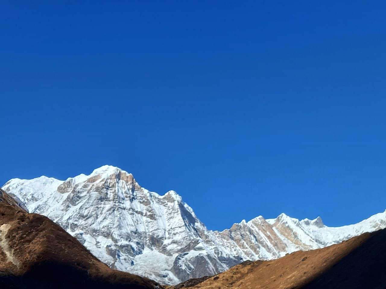 The Annapurna Base Camp (ABC) trek is one of Nepal’s premier, classic trekking routes, taking hikers into the heart of the Annapurna Massif at an altitude of 4,130 meters (13,550 feet). Surrounded by high peaks, including Annapurna I (8,091m), the 10th highest mountain in the world, the camp sits within a natural amphitheater known as the Annapurna Sanctuary.